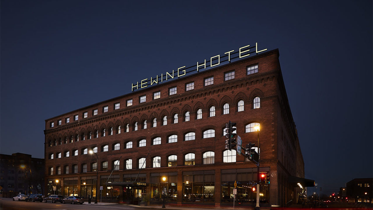 Exterior of Hewing Hotel in downtown Minneapolis, lit up at night