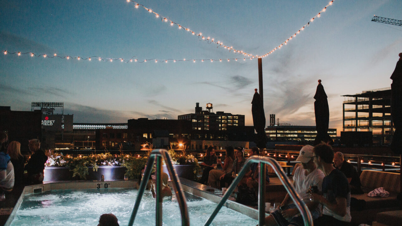 People gathered around our Minneapolis hotel's rooftop pool at night
