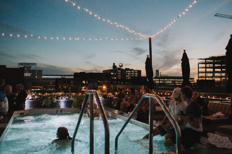 People gathered around our Minneapolis hotel's rooftop pool at night