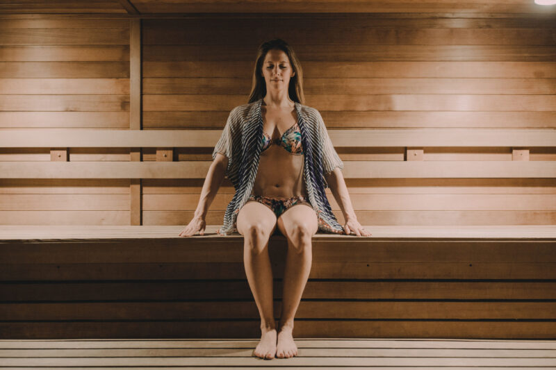 Woman in a swimsuit sitting in our Minneapolis hotel's sauna