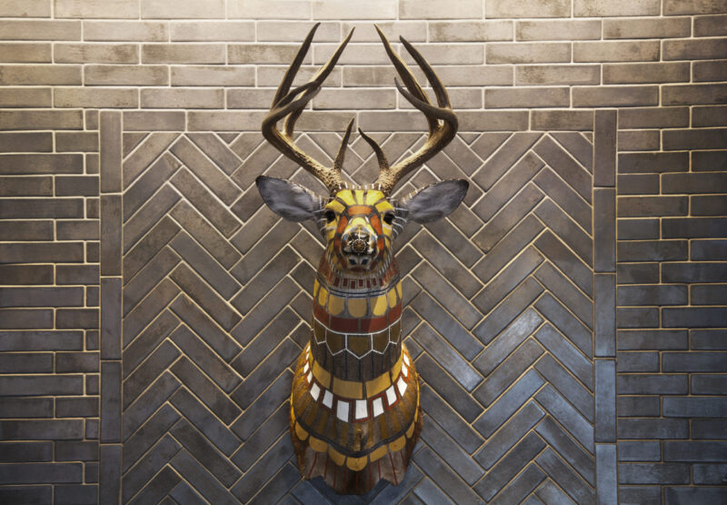 Colorful geometric painted deer head on the wall of our Minneapolis boutique hotel