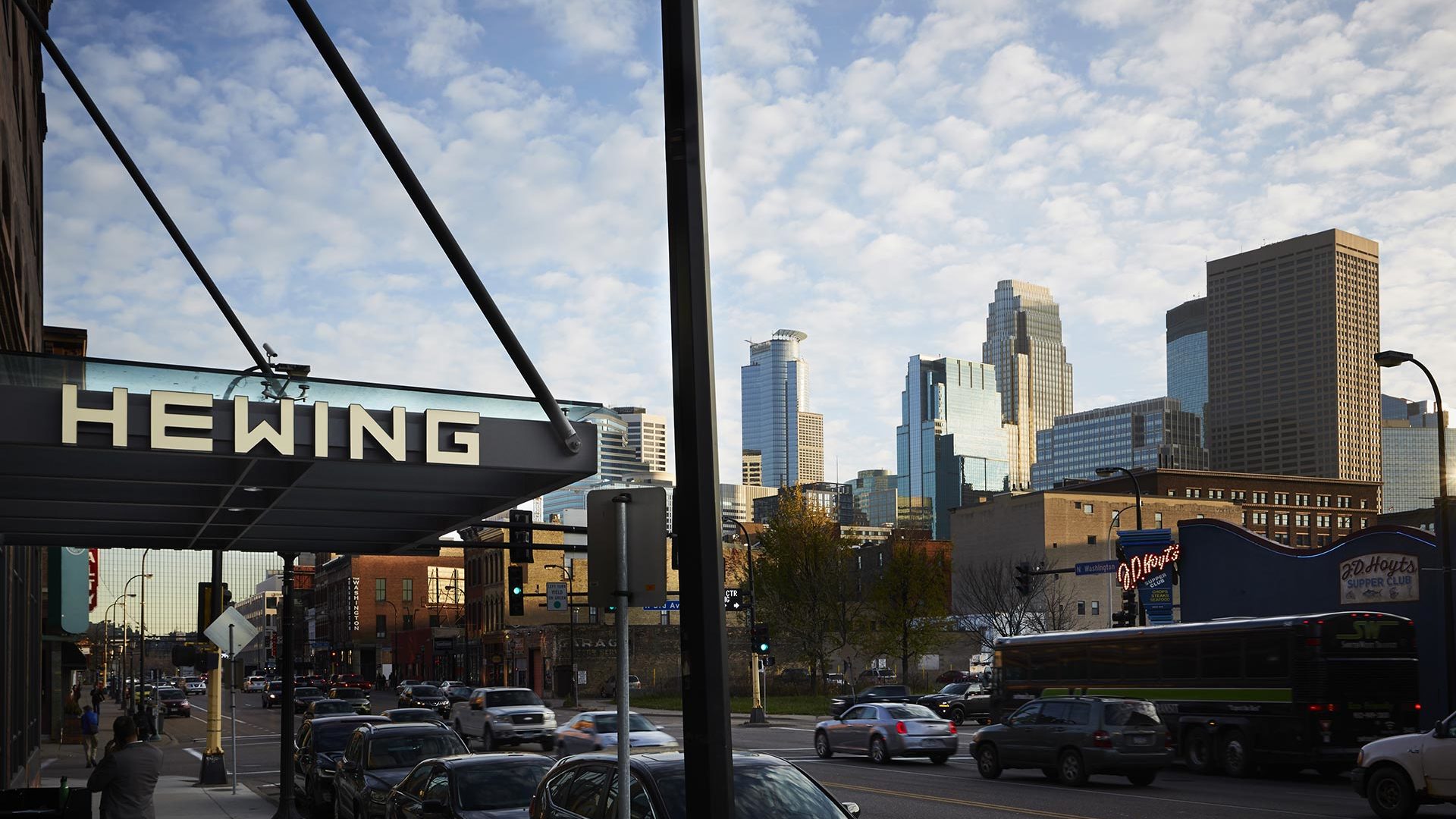Entrance sign for Hewing Hotel and the MPLS, MN downtown skyline