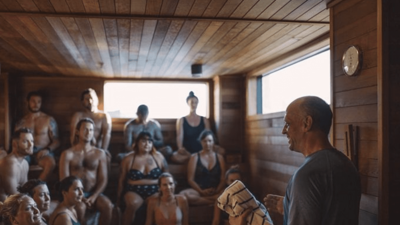 Man addressing a group of people in our rooftop Minneapolis sauna