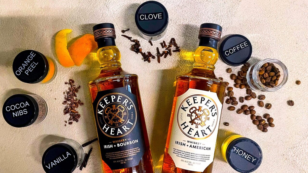 Two bottles of Keeper's Heart whiskey surrounded by various spice jars