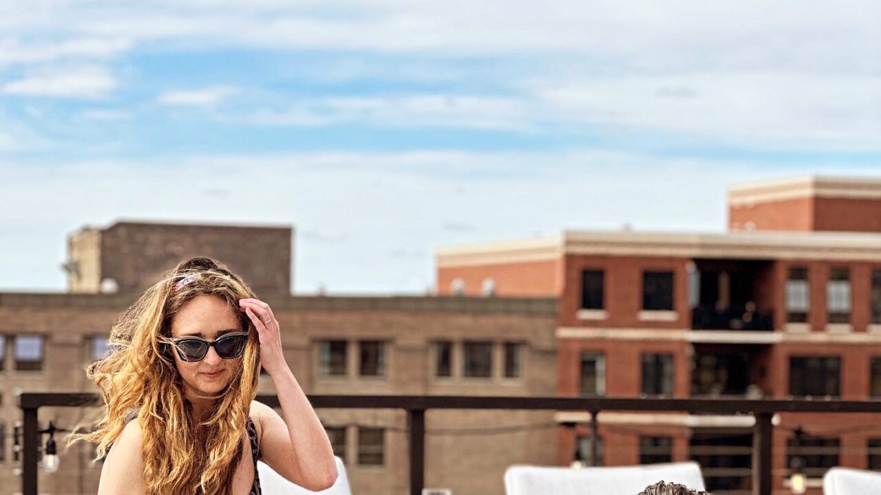 Couple lounging at the edge of the pool at our rooftop in Minneapolis